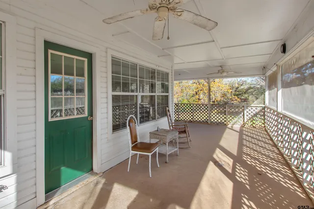 a balcony with chairs and table