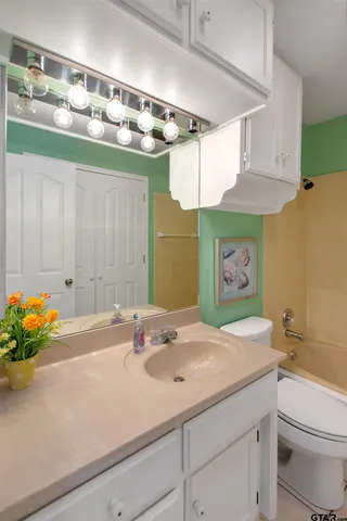 a bathroom with a sink a vanity and a mirror