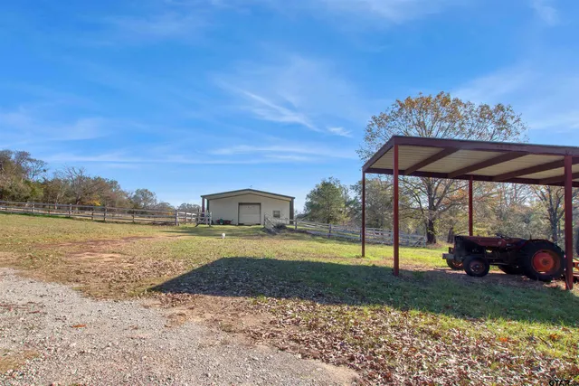 a view of a house with a yard and sitting area