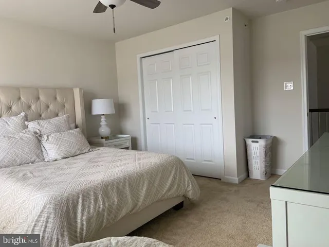 a bedroom with a bed and a mirror