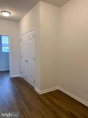 an empty room with wooden floor