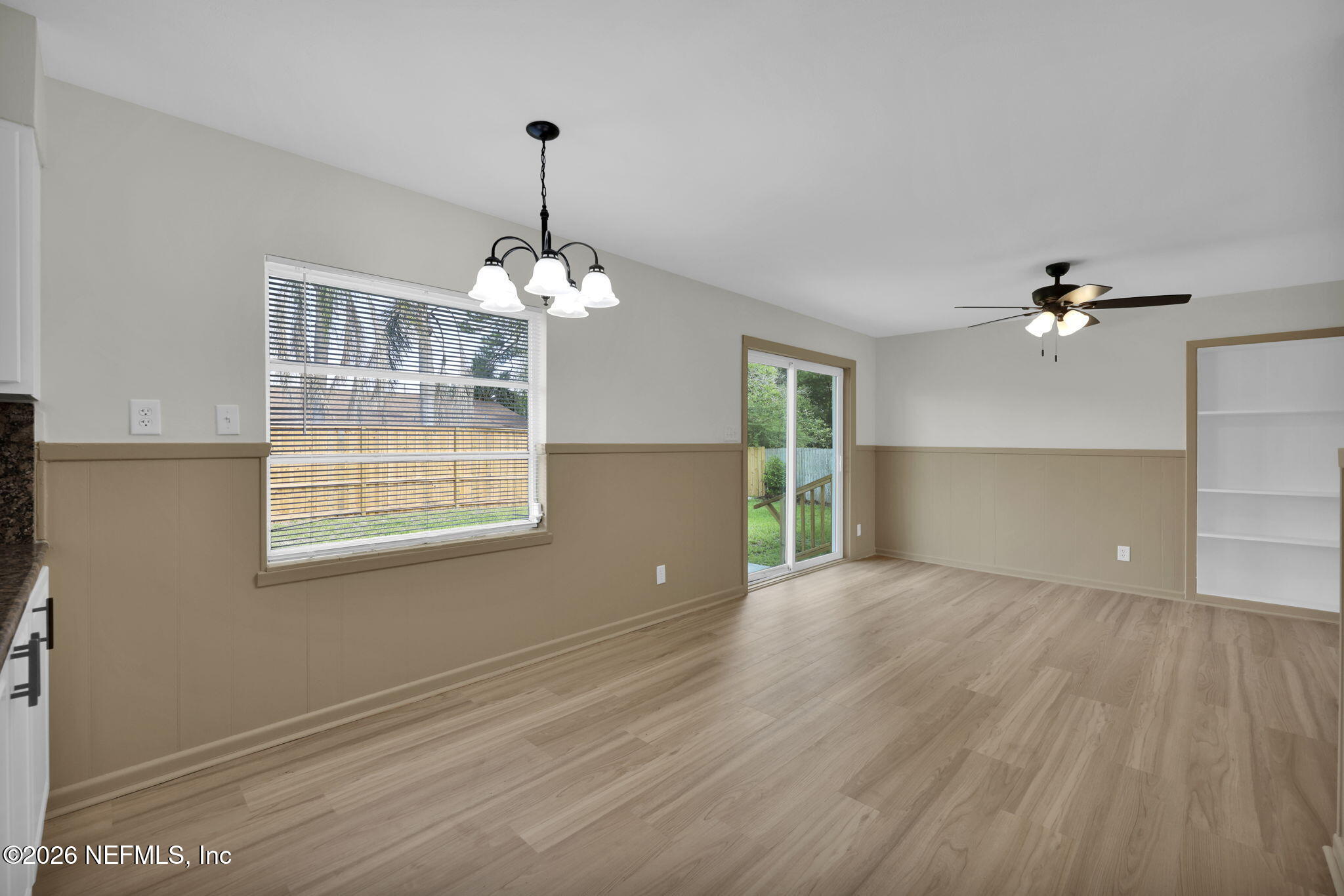 8544 Sanchez Road Jacksonville, FL 32217 - Photo 21 of 46 a view of an empty room with wooden floor and a window
