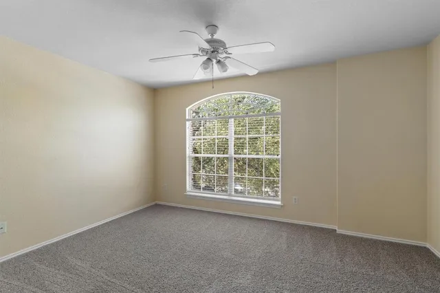 an empty room with a ceiling fan