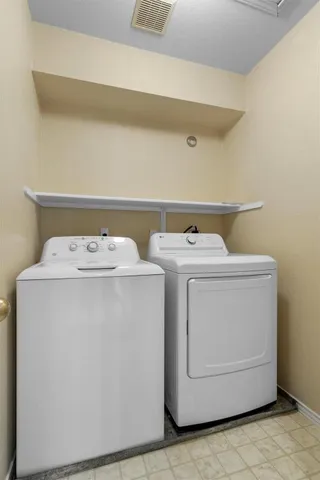 a view of a patio with couches table and chairs with potted plants and a barbeque