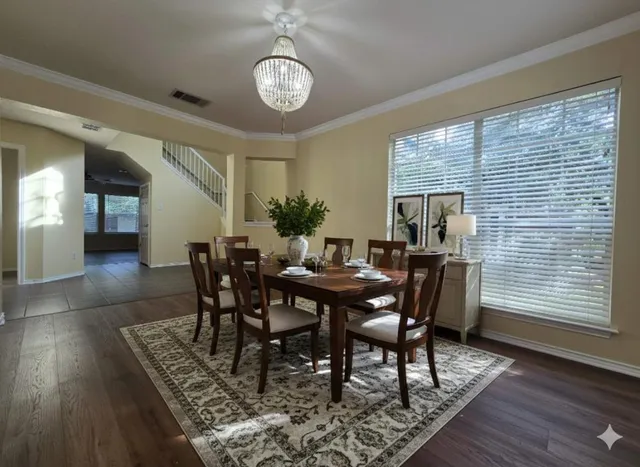 a view of a dining room with furniture window and wooden floor