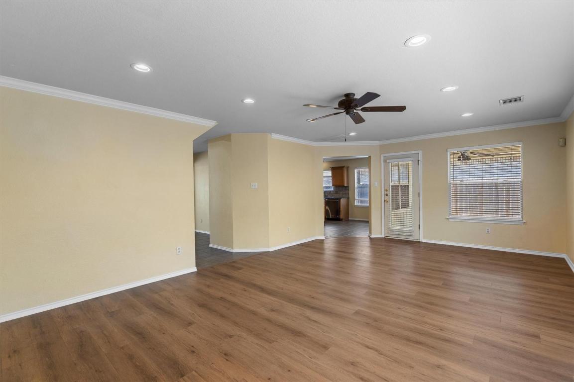 8336 Alvin High Lane Austin, TX 78729 - Photo 9 of 40 Unfurnished living room featuring ornamental molding, wood finished floors, recessed lighting, and a ceiling fan