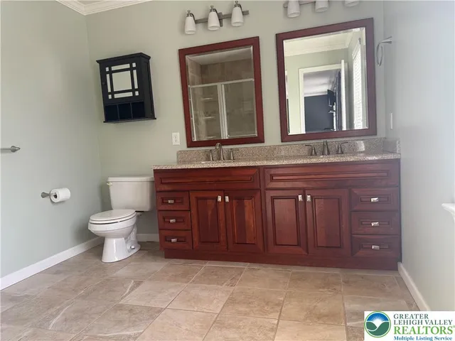 a bathroom with a toilet a sink and mirror