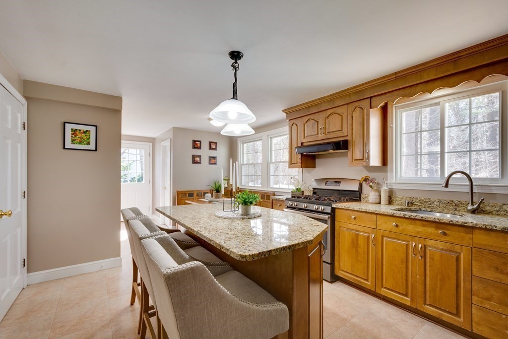95 Andover Road Billerica, MA 01821 - Photo 2 of 18 a kitchen that has a cabinets counter space dining table and a sink