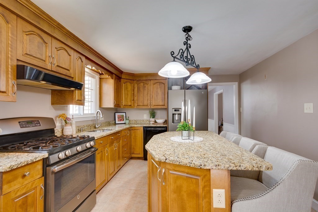 95 Andover Road Billerica, MA 01821 - Photo 5 of 18 a kitchen with stainless steel appliances granite countertop a sink a stove and a wooden cabinets