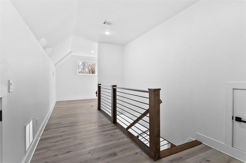 658 Rockbridge Road Northwest Lilburn, GA 30047 - Photo 11 of 61 a view of a hallway with wooden floor and staircase