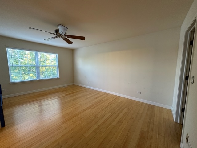 1903 Ridgemoor Drive Plainfield, IL 60586 - Photo 13 of 19 a view of empty room with wooden floor and fan