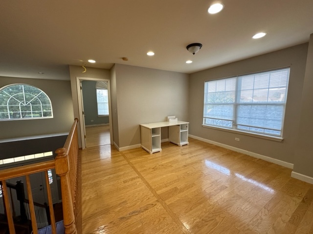 1903 Ridgemoor Drive Plainfield, IL 60586 - Photo 7 of 19 a view of an empty room with a window and wooden floor