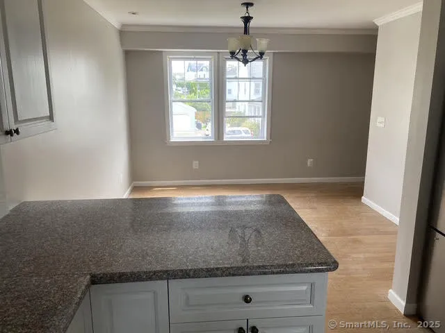 a view of a hallway with wooden floor and closet area