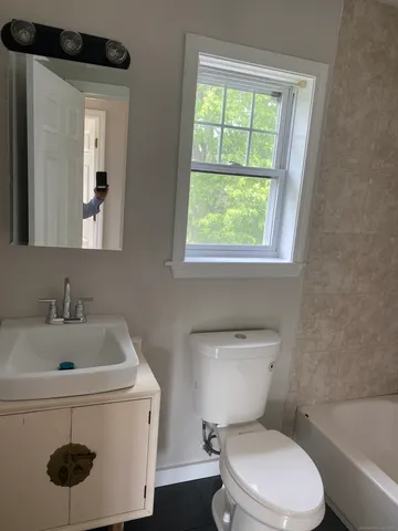 a view of a room with wooden floor and window