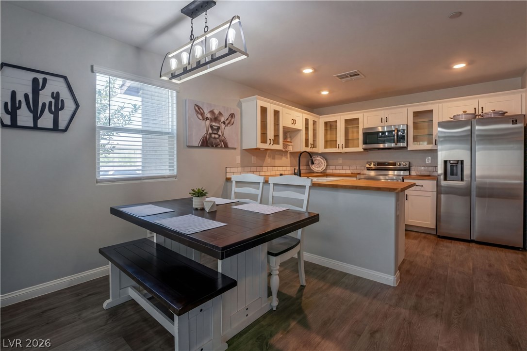 12267 Desert Light Road, Unit 4 Las Vegas, NV 89183 - Photo 2 of 18 Kitchen features stainless steel appliances, light-toned cabinetry, and rich wood flooring.