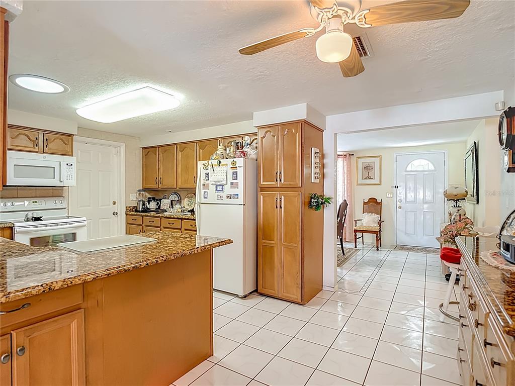 1646 Cockleshell Drive Holiday, FL 34690 - Photo 11 of 36 a kitchen with stainless steel appliances granite countertop a refrigerator and a sink