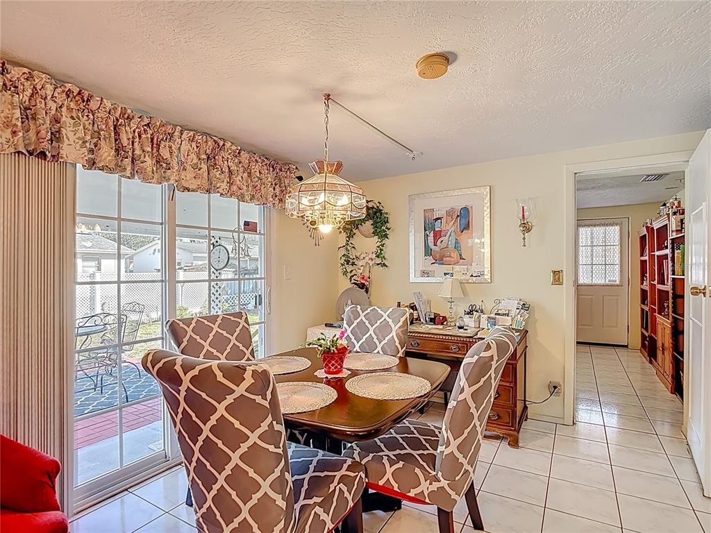 1646 Cockleshell Drive Holiday, FL 34690 - Photo 13 of 36 a view of a dining room with furniture and chandelier
