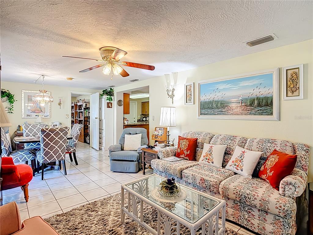1646 Cockleshell Drive Holiday, FL 34690 - Photo 17 of 36 a living room with furniture a dining table and a piano