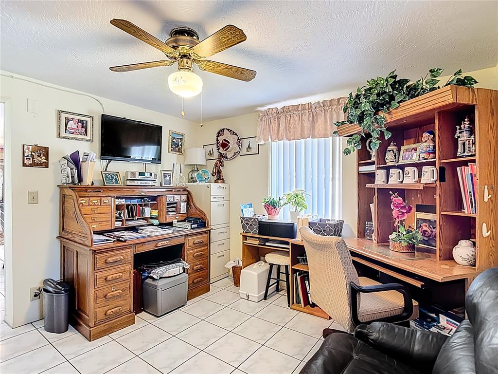 1646 Cockleshell Drive Holiday, FL 34690 - Photo 19 of 36 a work room with furniture and a flat screen tv