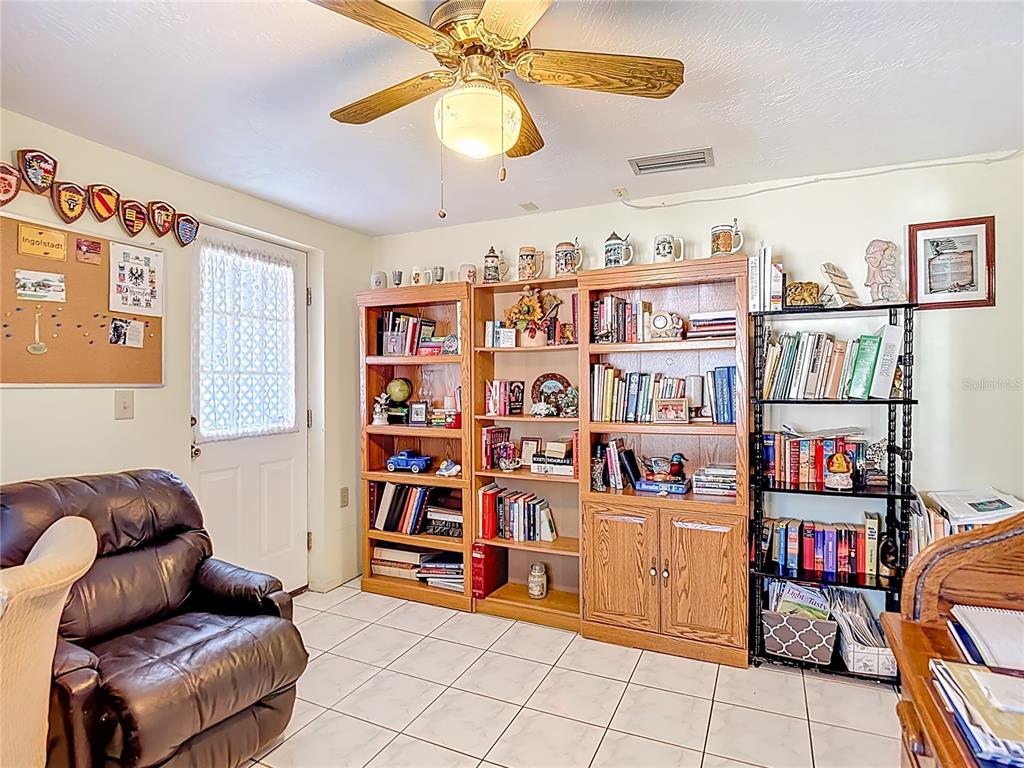 1646 Cockleshell Drive Holiday, FL 34690 - Photo 20 of 36 a living room with lots of furniture and baby book shelf
