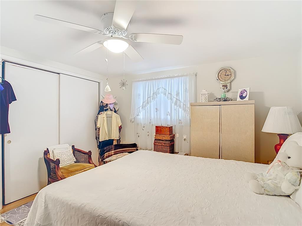 1646 Cockleshell Drive Holiday, FL 34690 - Photo 22 of 36 a bedroom with a bed and a chandelier