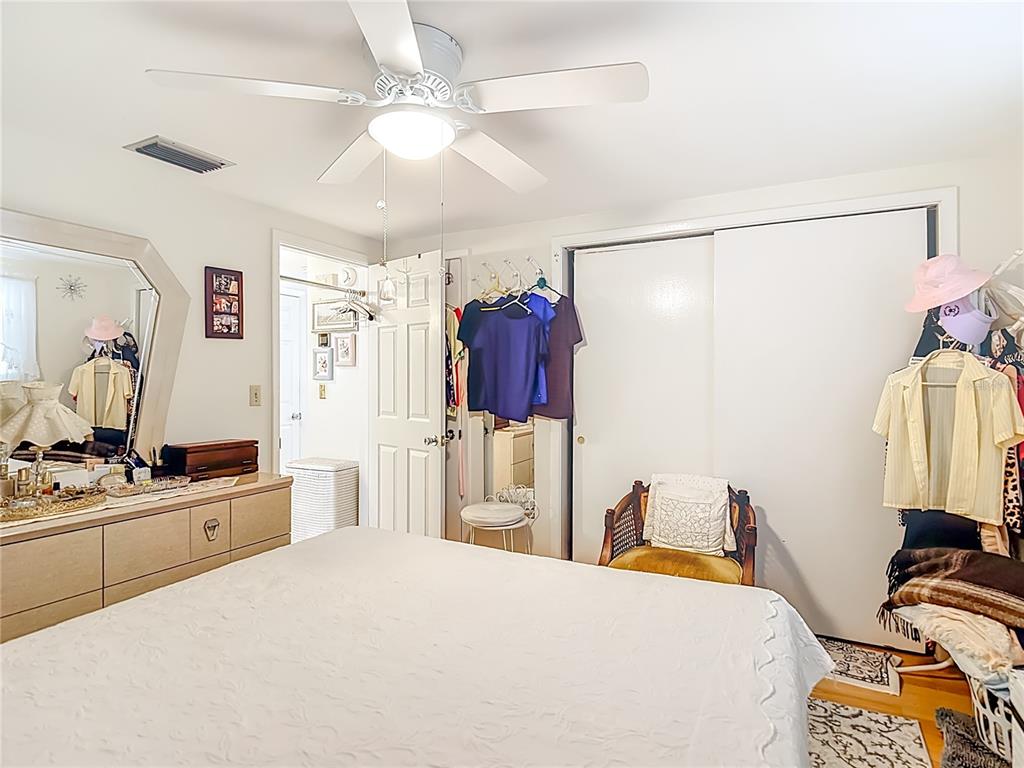 1646 Cockleshell Drive Holiday, FL 34690 - Photo 23 of 36 a bedroom with a bed and a chandelier