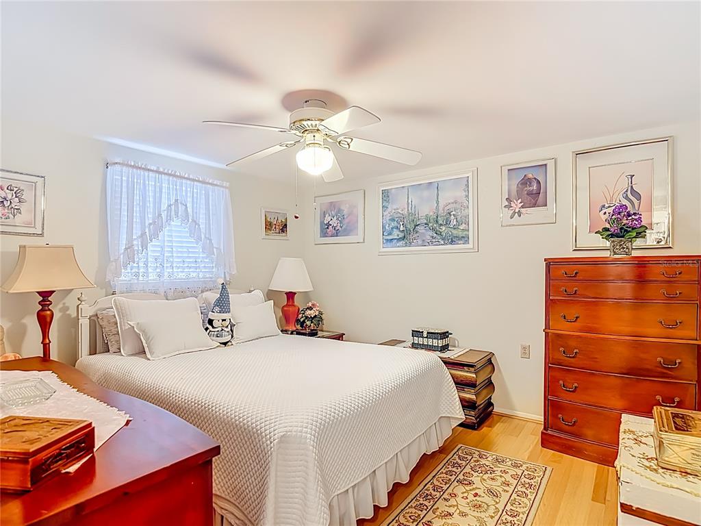 1646 Cockleshell Drive Holiday, FL 34690 - Photo 24 of 36 a bedroom with a bed and a chandelier