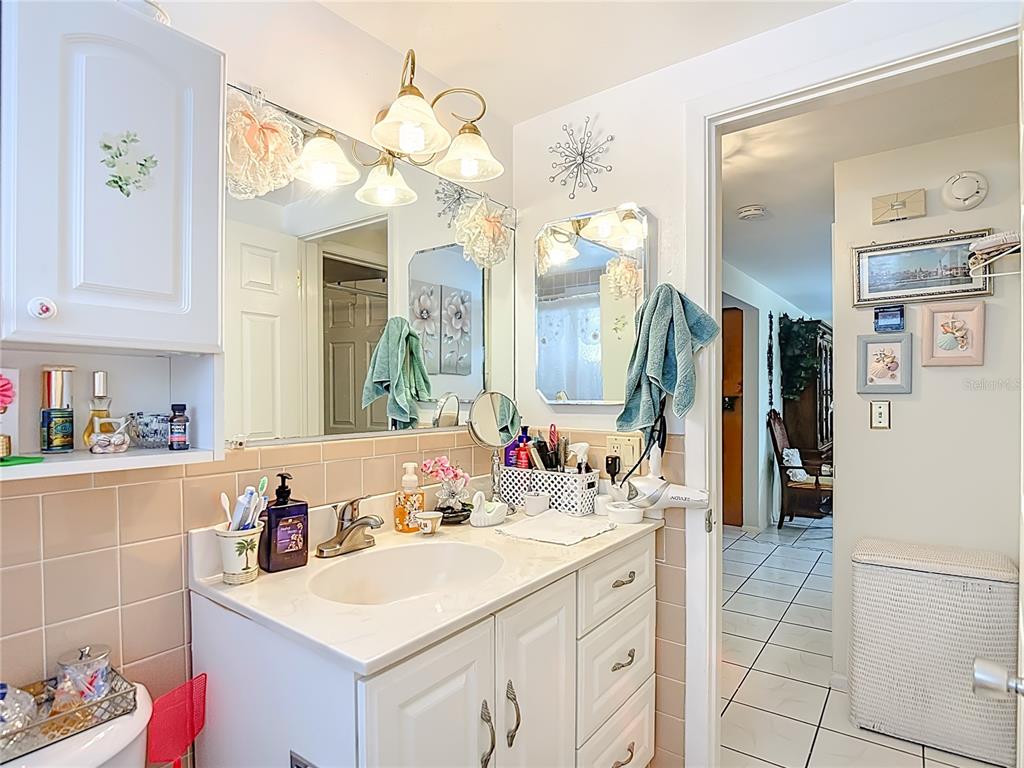 1646 Cockleshell Drive Holiday, FL 34690 - Photo 27 of 36 a bathroom with a sink vanity and a mirror