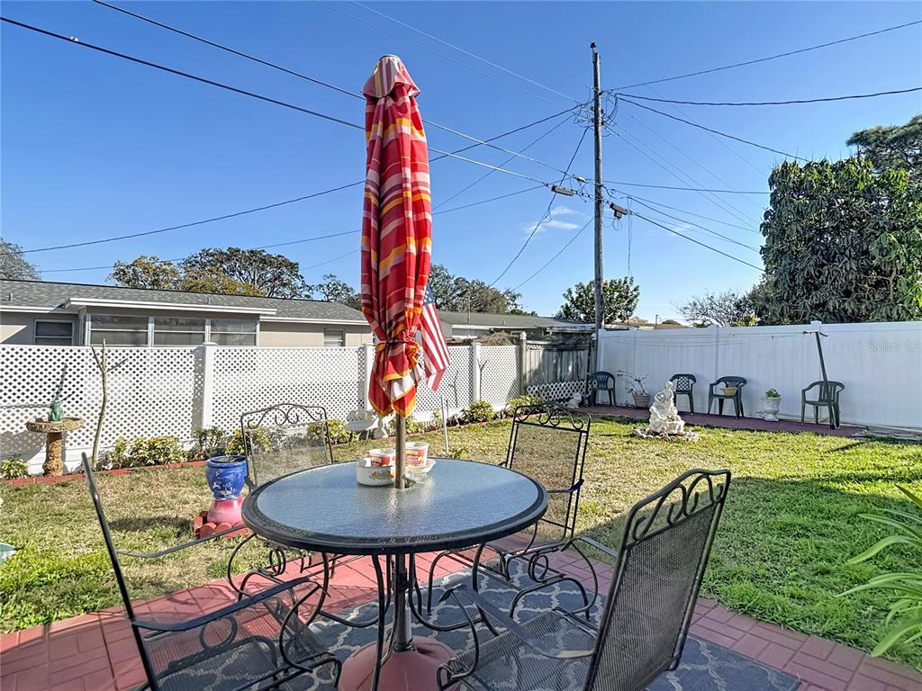 1646 Cockleshell Drive Holiday, FL 34690 - Photo 32 of 36 a view of a swimming pool with a table and chairs