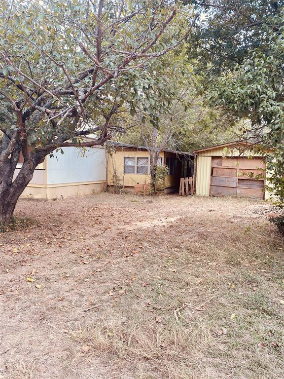114 County Road 1423 Morgan, TX 76671 - Photo 2 of 10 a view of a house with a yard