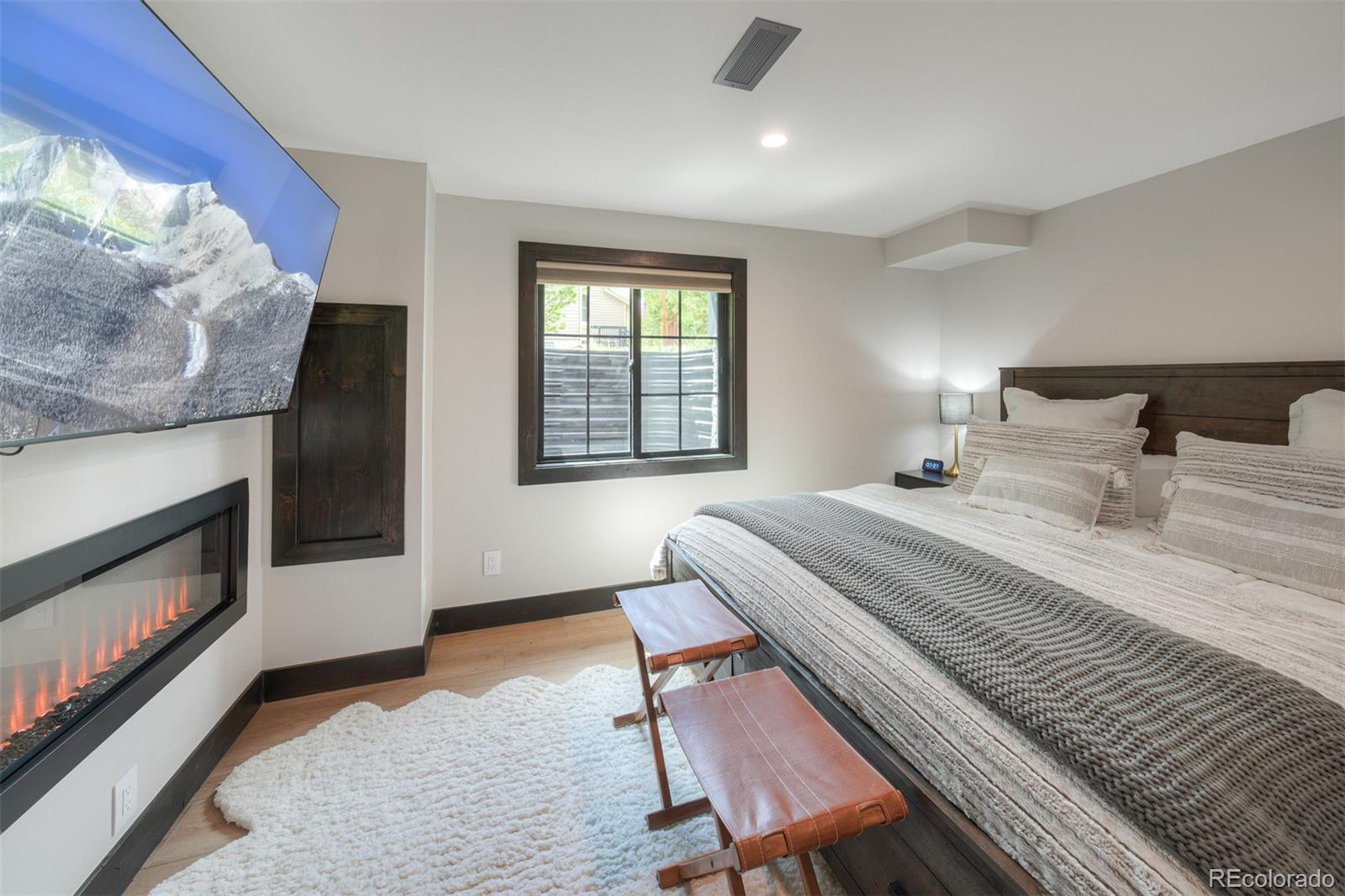 306 Golden Eagle Road Silverthorne, CO 80498 - Photo 33 of 43 a bedroom with a bed and a fireplace