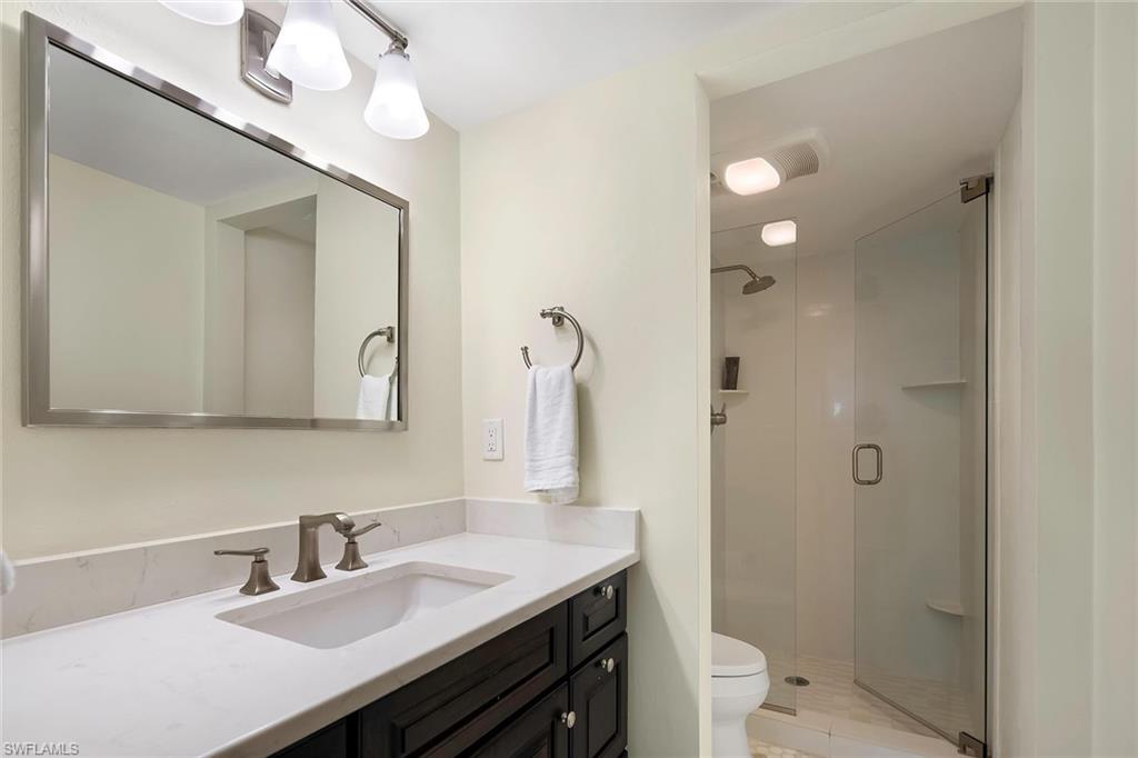 4160 Crayton Road, Unit A5 Naples, FL 34103 - Photo 14 of 46 Ensuite bath with seamless glass shower doors