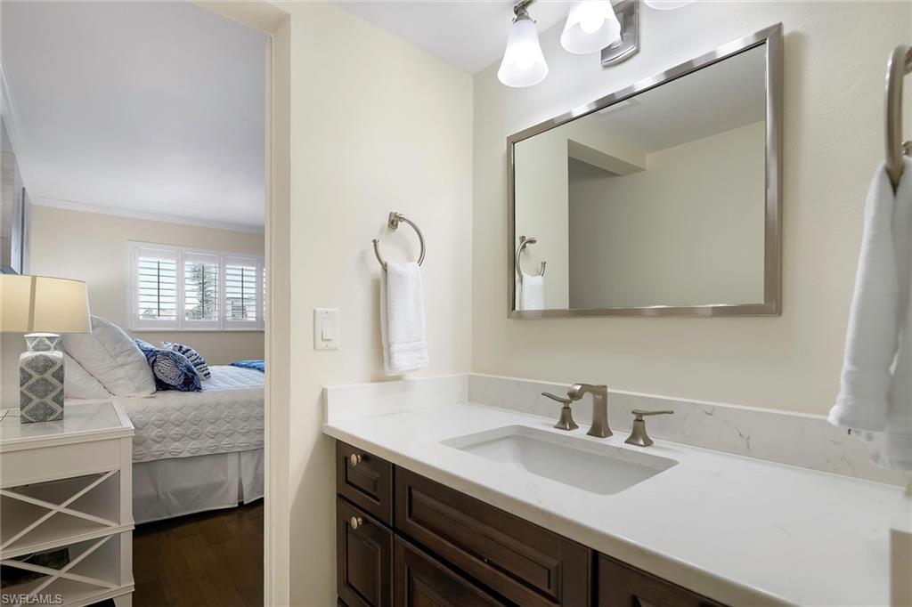 4160 Crayton Road, Unit A5 Naples, FL 34103 - Photo 29 of 46 Remodeled ensuite primary bath with modern finishes