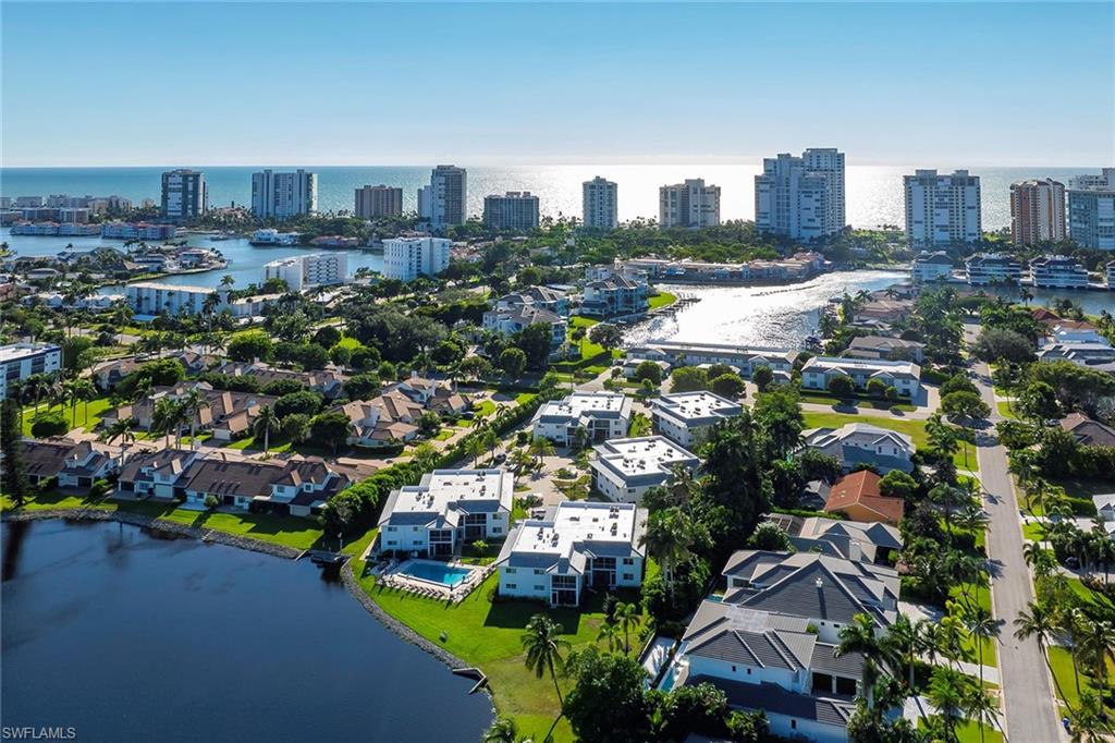 4160 Crayton Road, Unit A5 Naples, FL 34103 - Photo 37 of 46 Aerial view captures the Bay and Gulf glowing in the sun