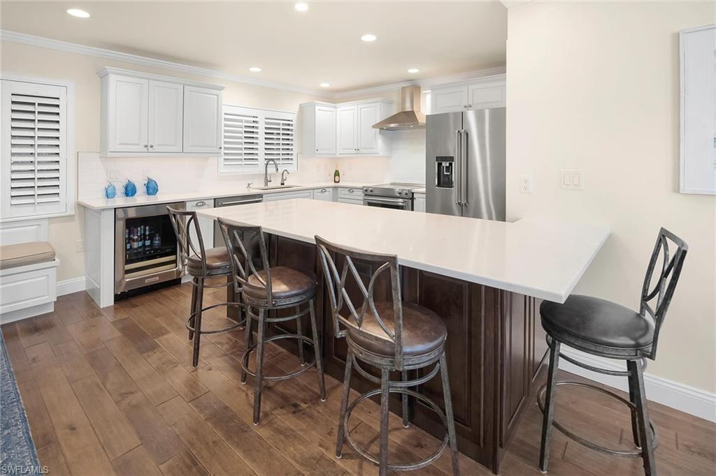 4160 Crayton Road, Unit A5 Naples, FL 34103 - Photo 8 of 46 Completely remodeled kitchen with island and high-end finishes