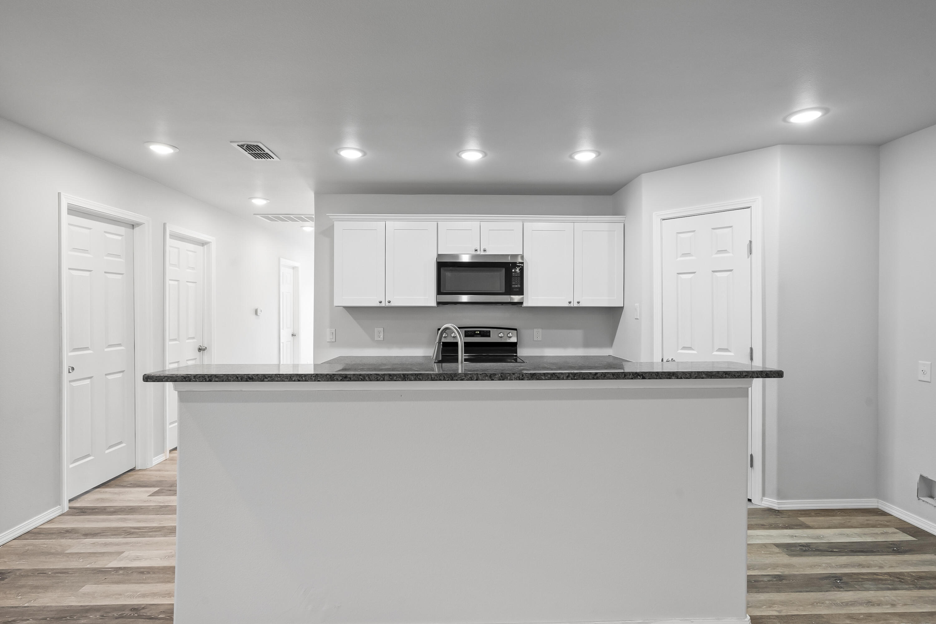 5609 Jarvis Street, Unit B Lubbock, TX 79416 - Photo 11 of 24 a large kitchen with stainless steel appliances granite countertop a sink and a stove