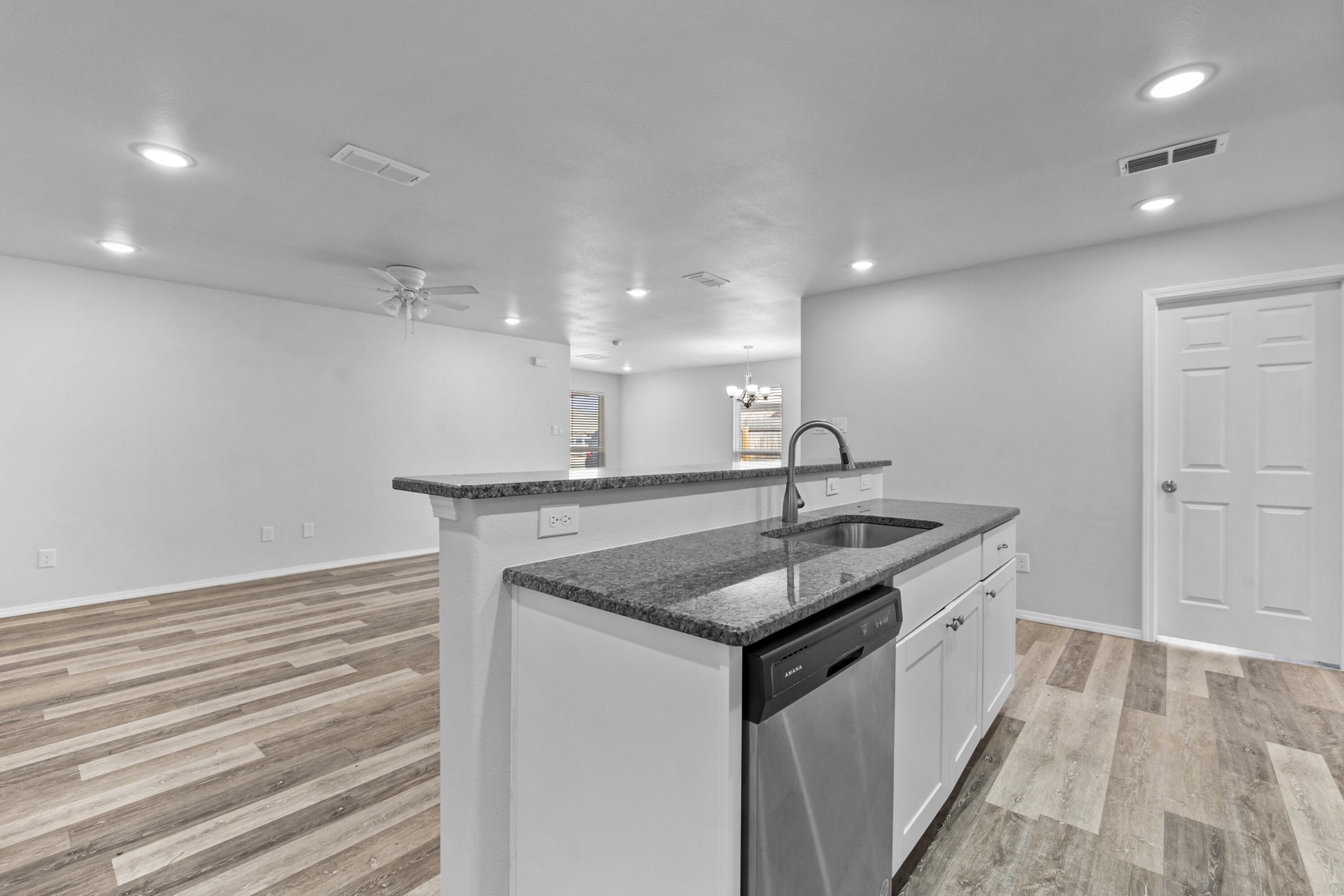 5609 Jarvis Street, Unit B Lubbock, TX 79416 - Photo 14 of 24 a kitchen with a sink dishwasher and a stove with wooden floor