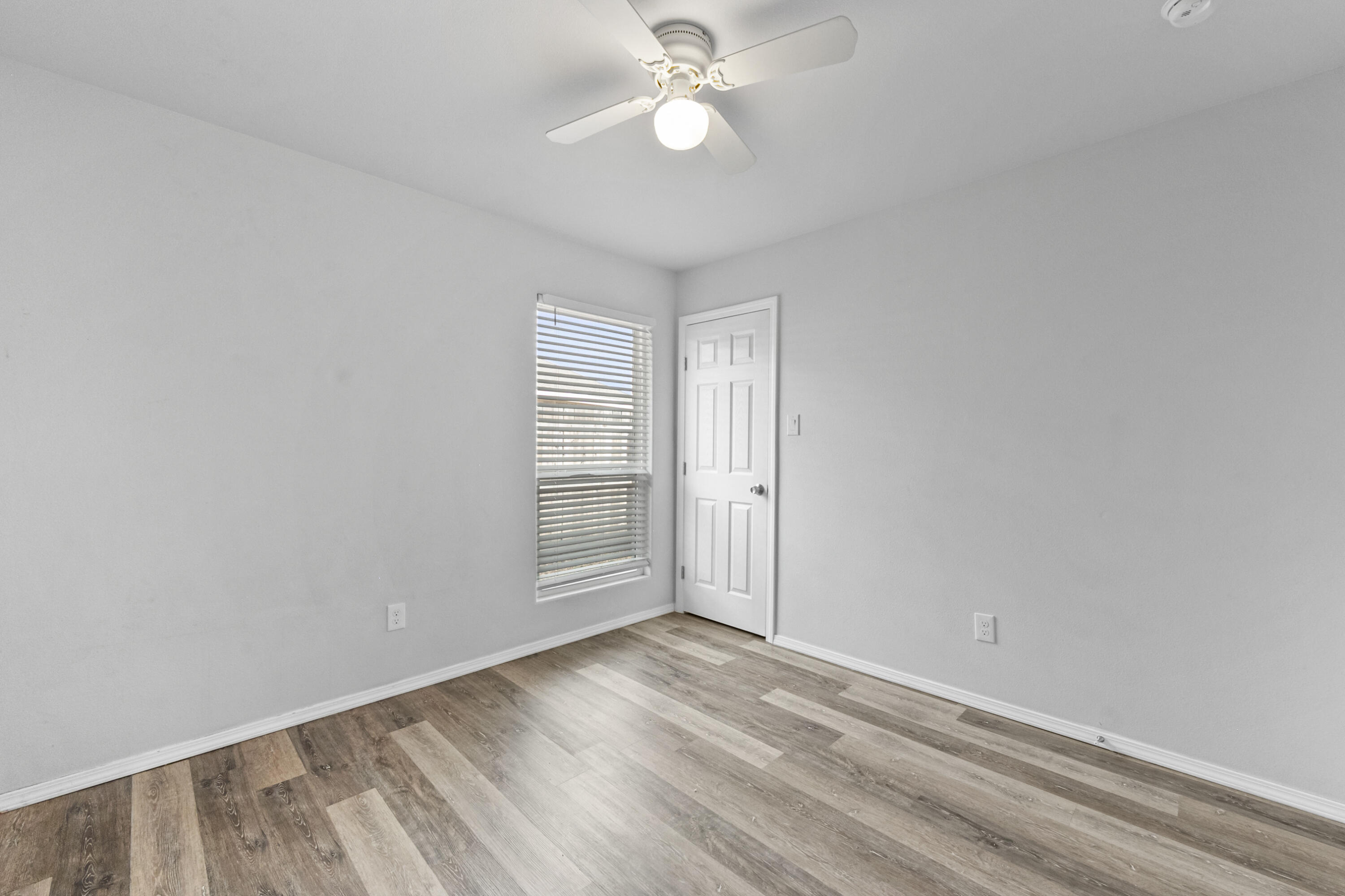 5609 Jarvis Street, Unit B Lubbock, TX 79416 - Photo 15 of 24 wooden floor in an empty room with a window