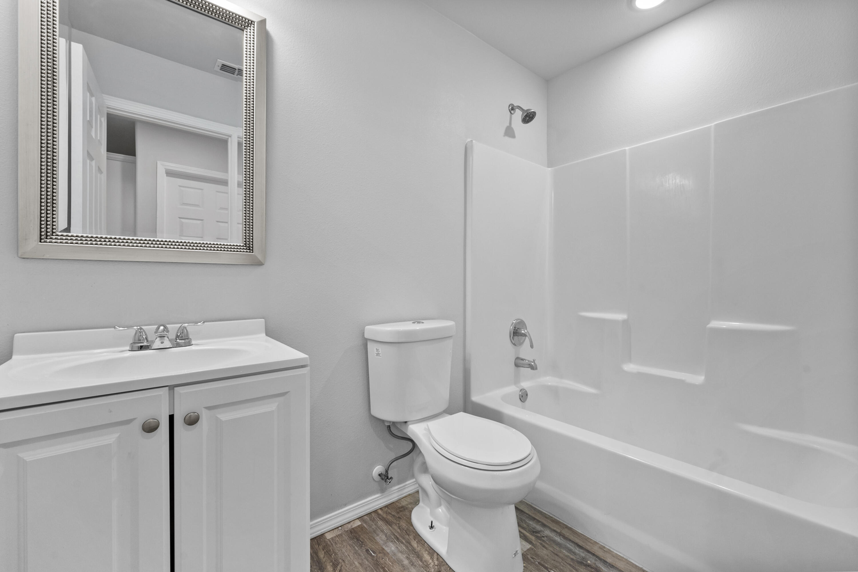 5609 Jarvis Street, Unit B Lubbock, TX 79416 - Photo 16 of 24 a bathroom with a sink a toilet and shower