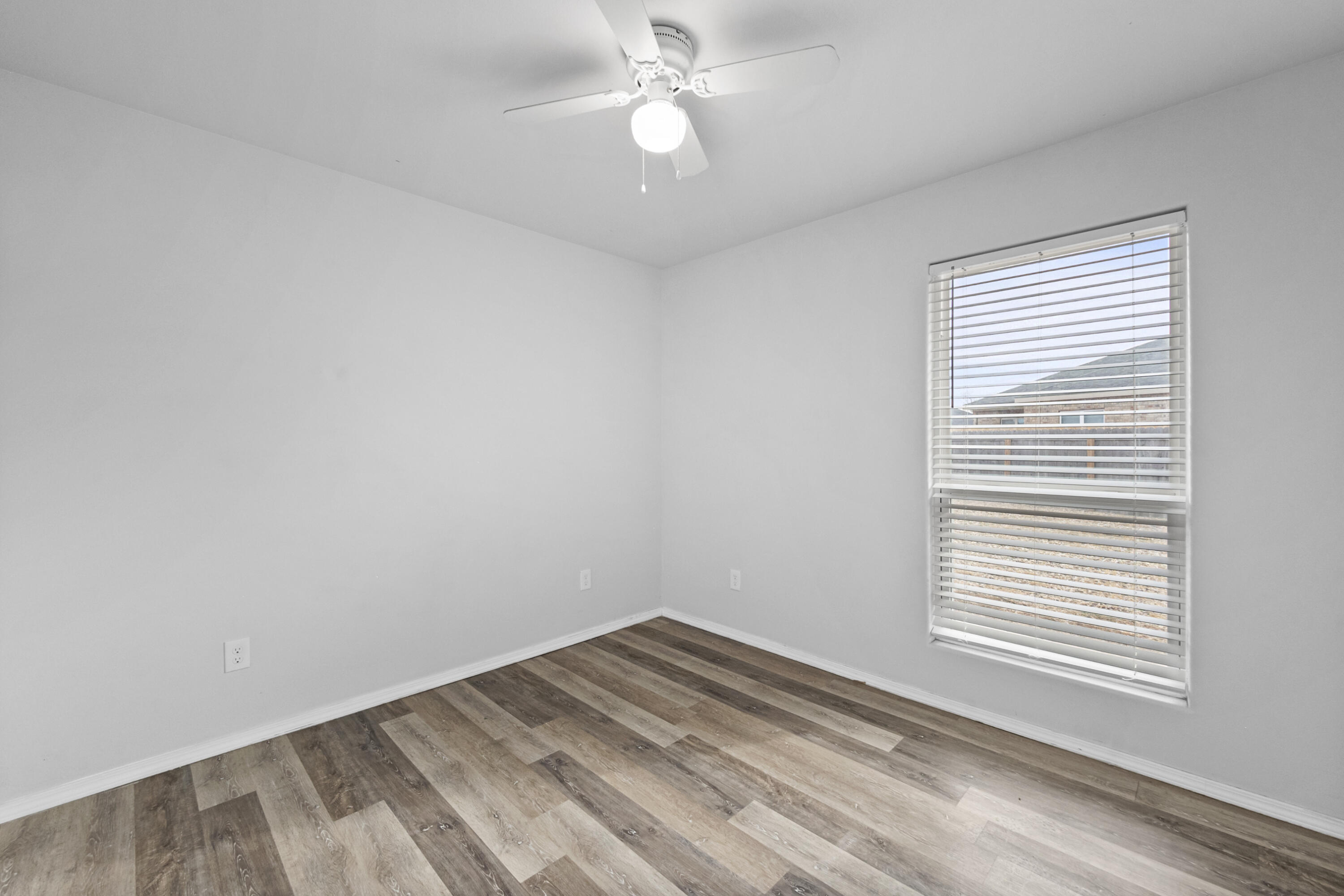 5609 Jarvis Street, Unit B Lubbock, TX 79416 - Photo 18 of 24 wooden floor in an empty room with a window