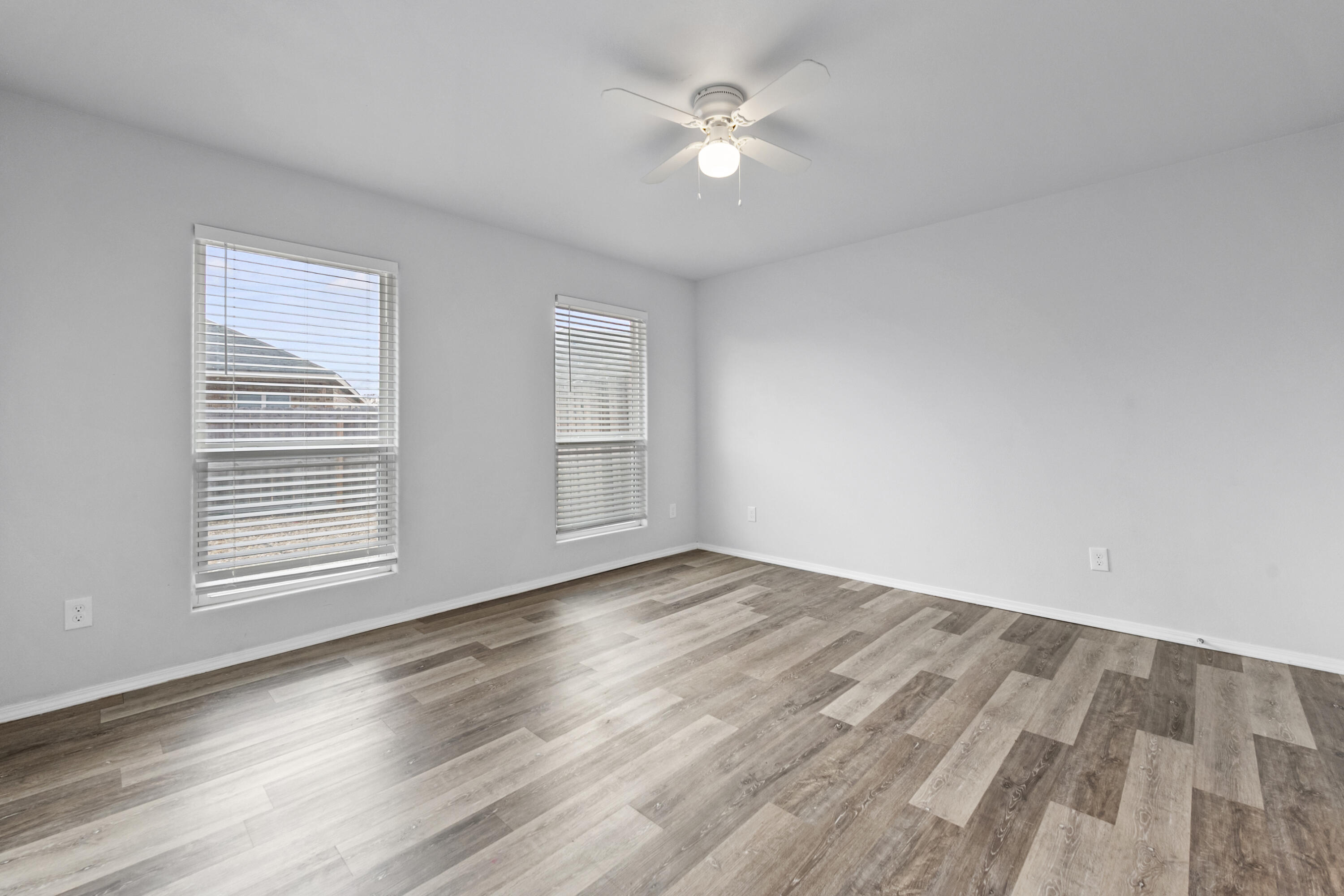 5609 Jarvis Street, Unit B Lubbock, TX 79416 - Photo 19 of 24 an empty room with wooden floor and window