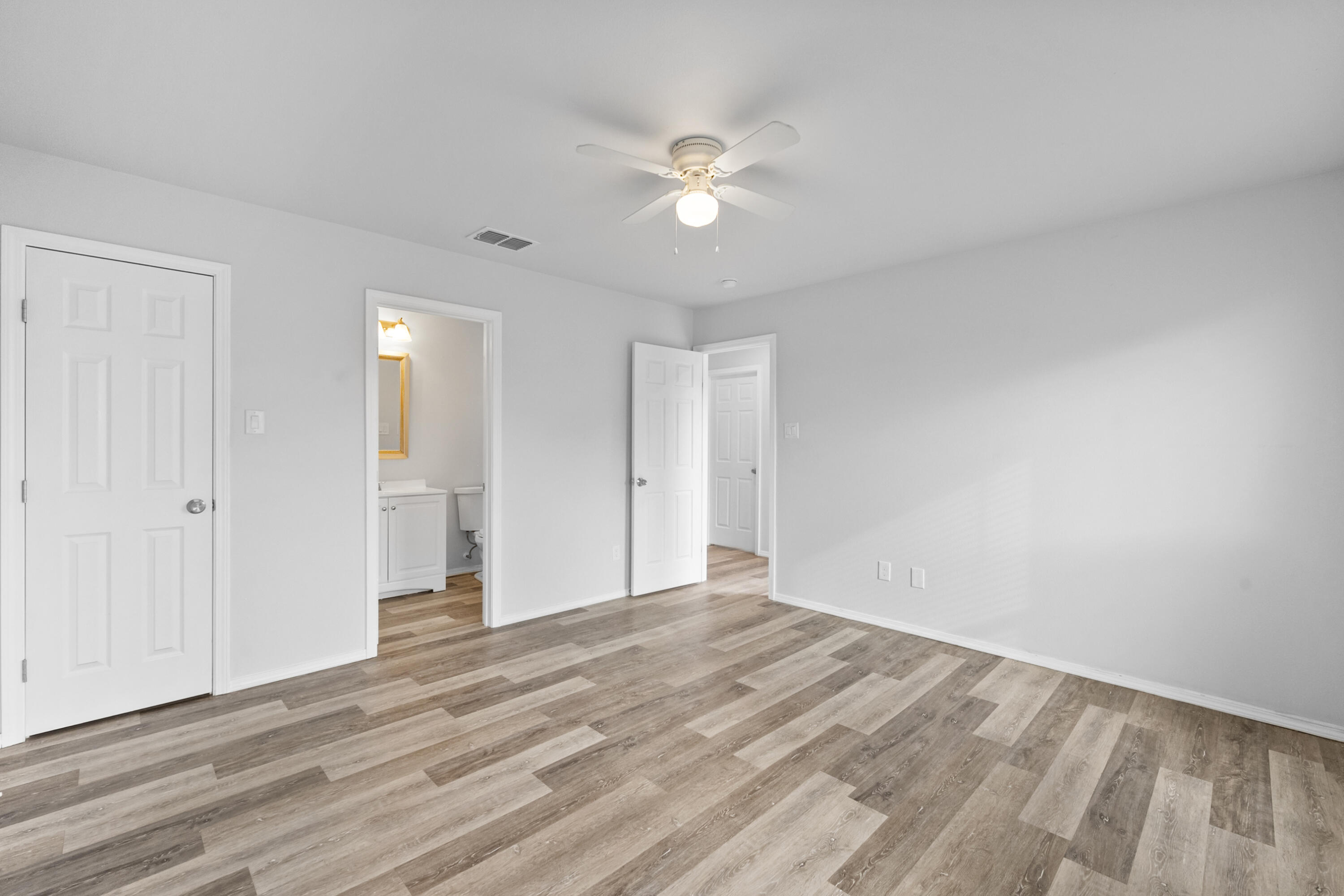 5609 Jarvis Street, Unit B Lubbock, TX 79416 - Photo 20 of 24 a view of a room with wooden floor and a ceiling fan