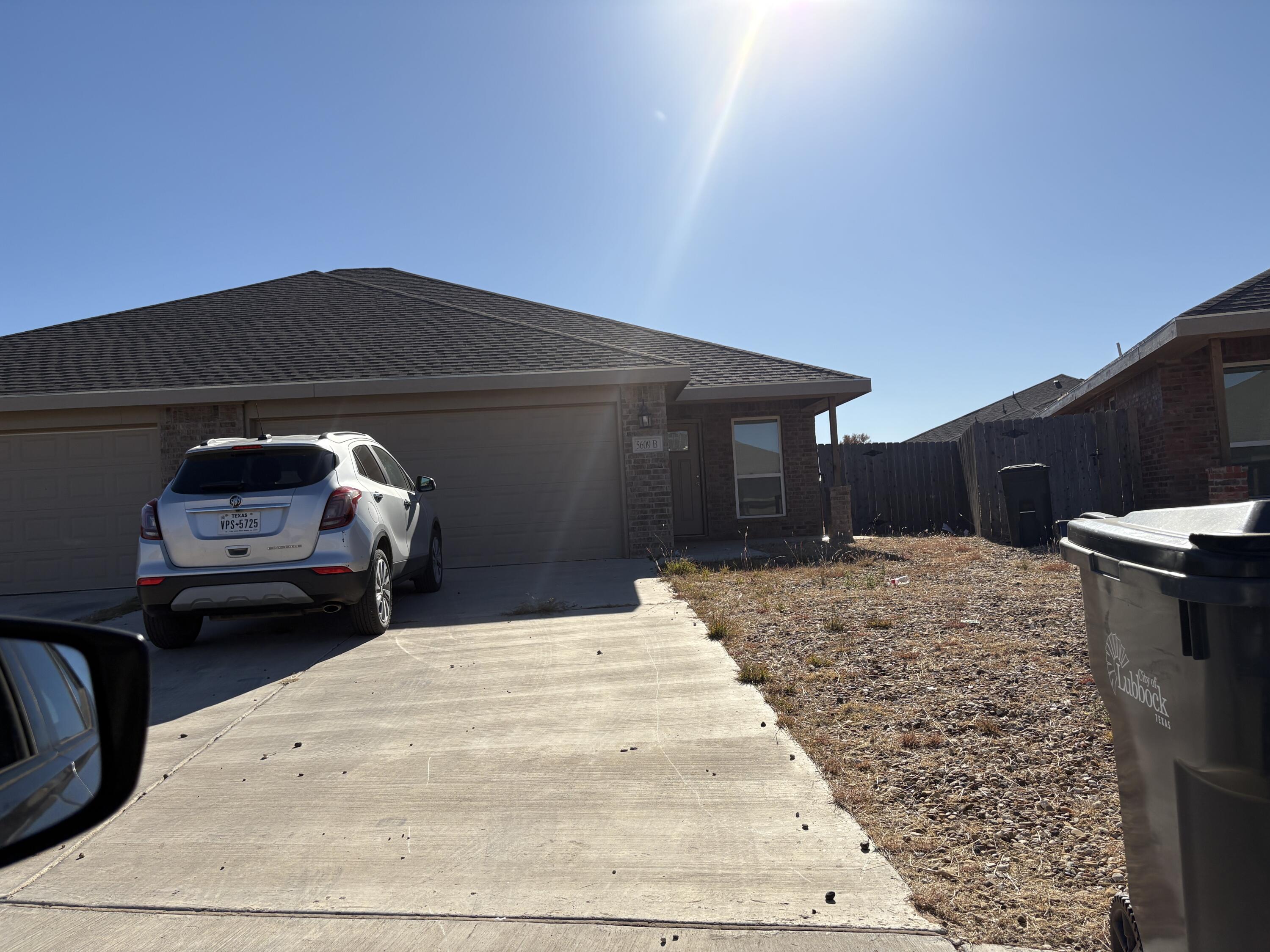 5609 Jarvis Street, Unit B Lubbock, TX 79416 - Photo 2 of 24 a black car in front of house