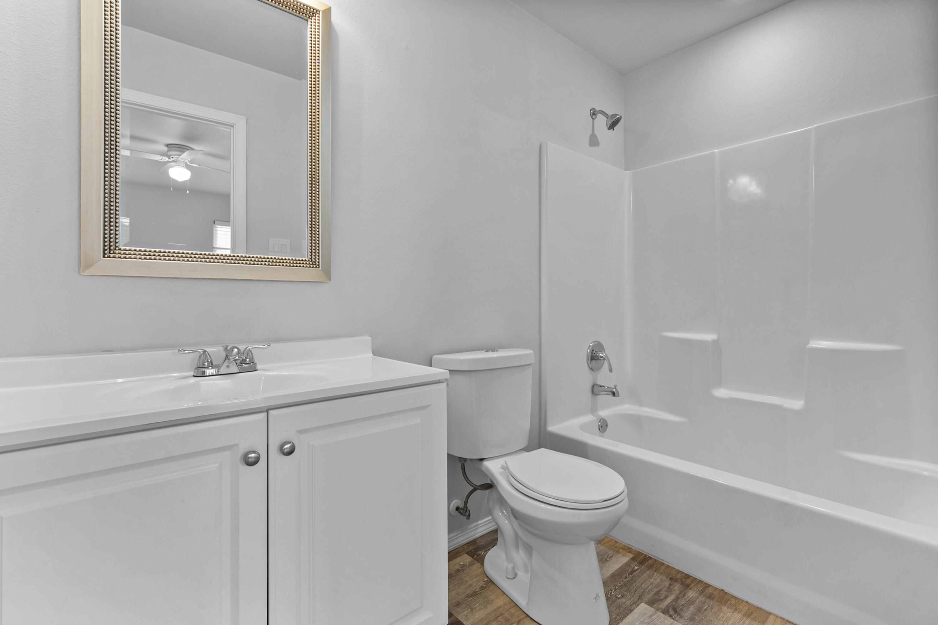 5609 Jarvis Street, Unit B Lubbock, TX 79416 - Photo 21 of 24 a bathroom with a toilet sink vanity tub and shower