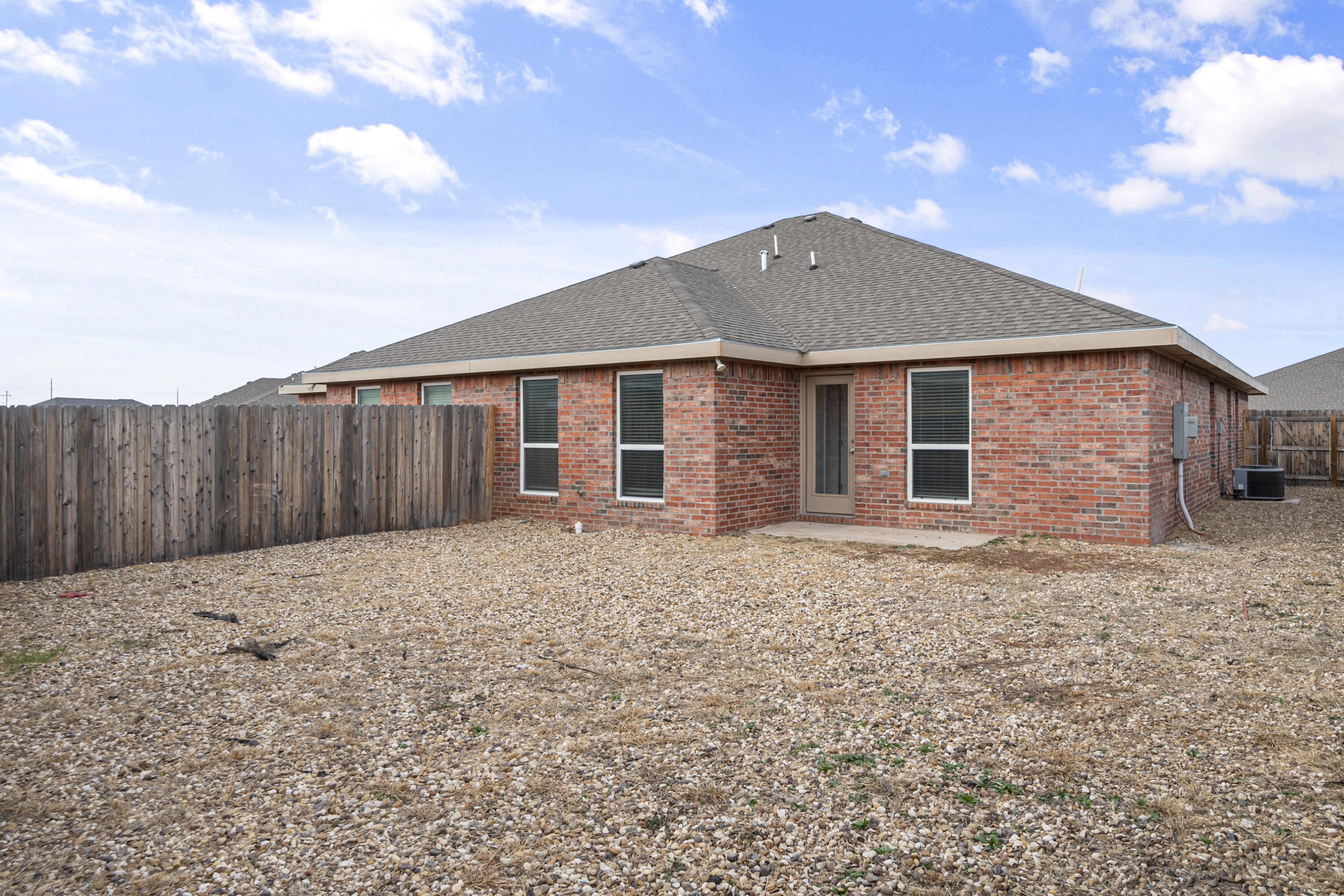5609 Jarvis Street, Unit B Lubbock, TX 79416 - Photo 23 of 24 a front view of a house with a yard