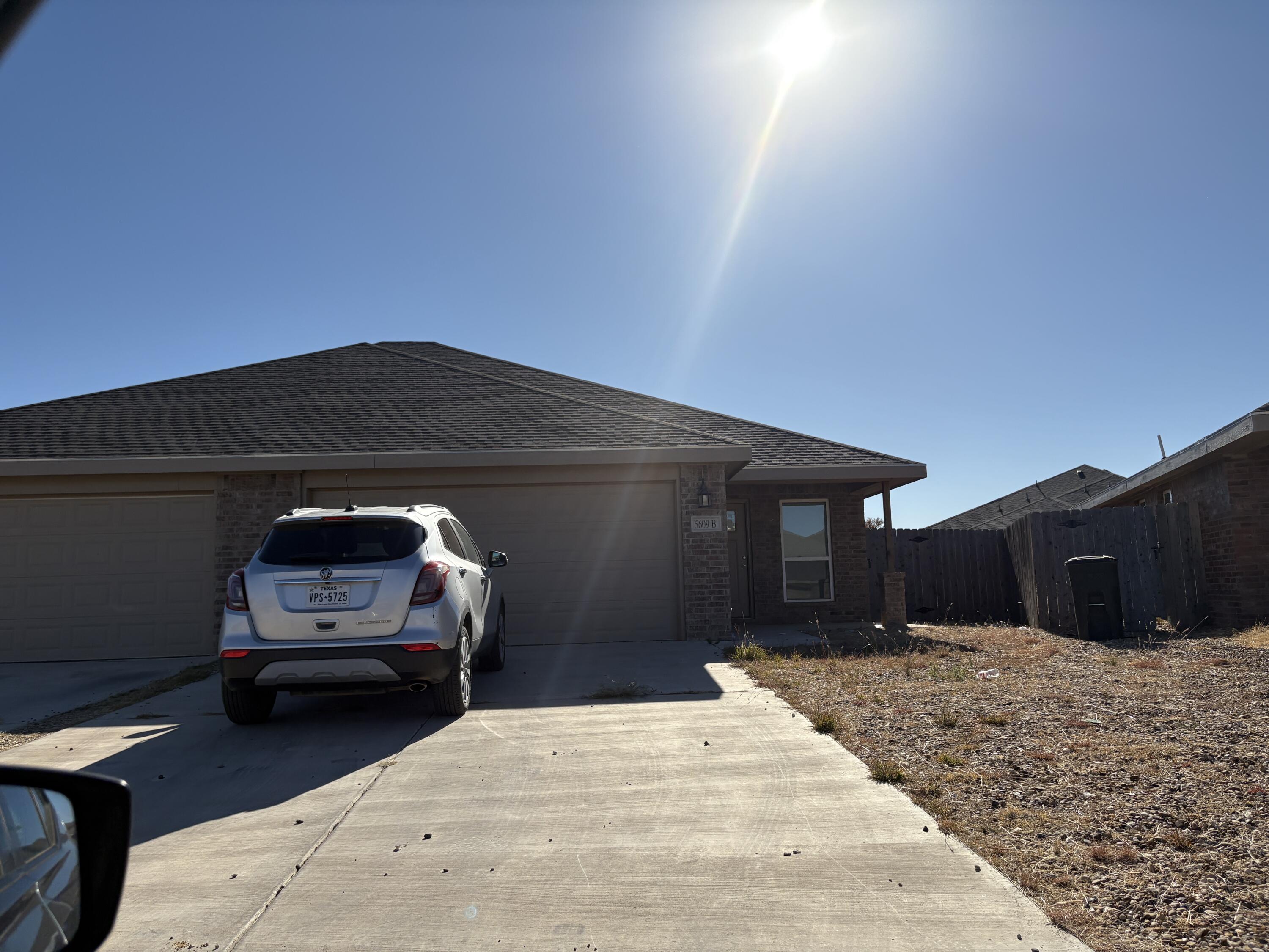 5609 Jarvis Street, Unit B Lubbock, TX 79416 - Photo 3 of 24 a car parked in front of a house