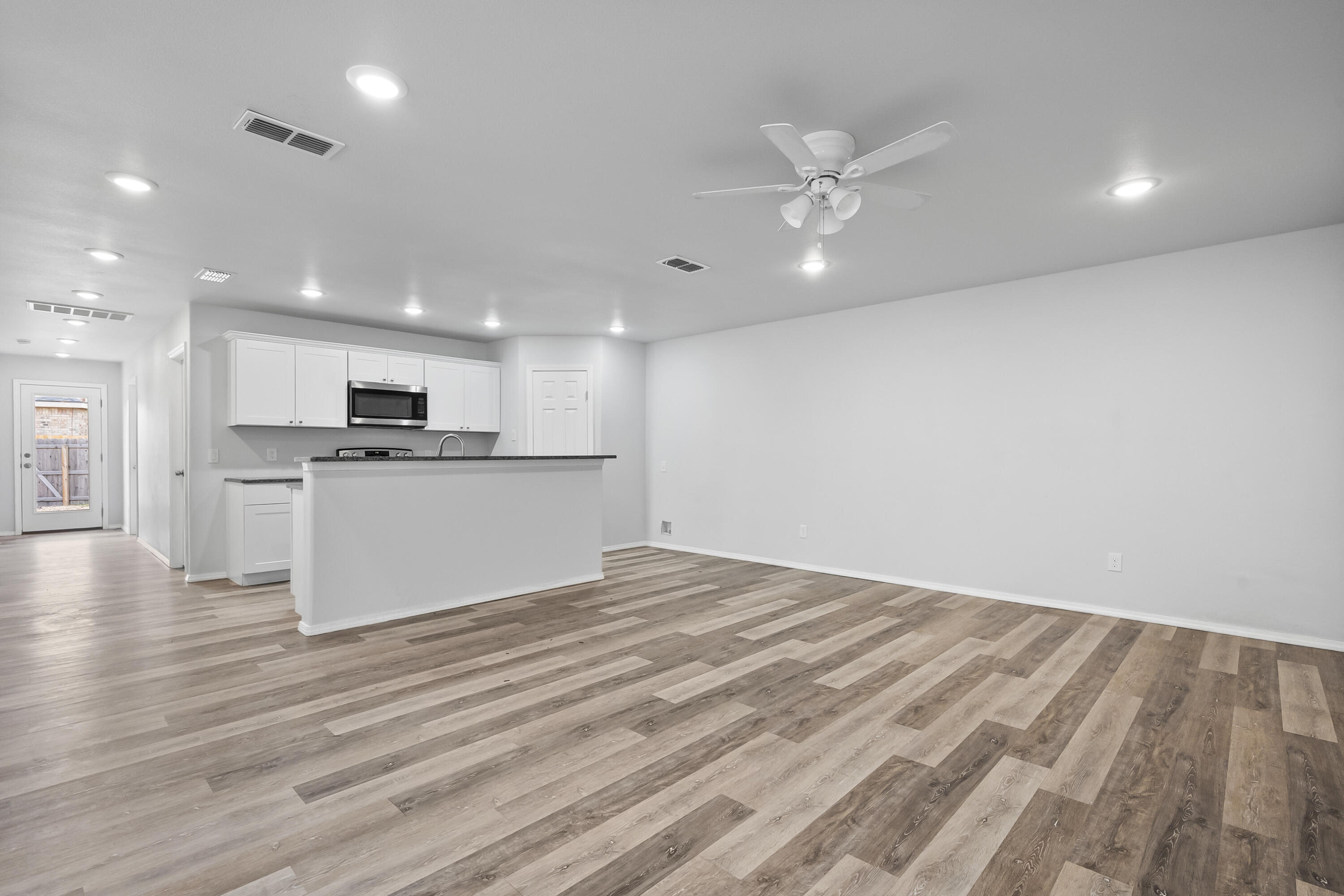 5609 Jarvis Street, Unit B Lubbock, TX 79416 - Photo 5 of 24 a view of kitchen with cabinets and wooden floor