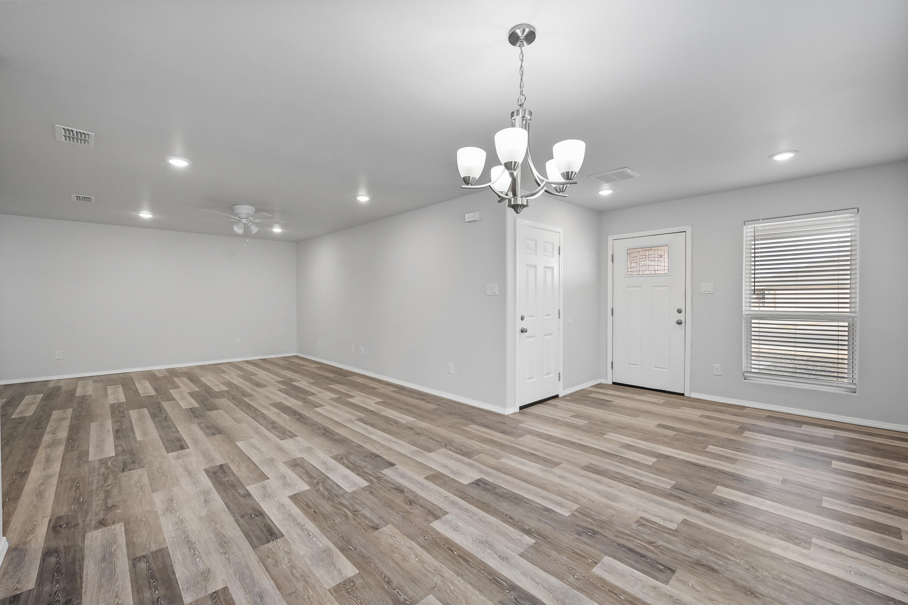 5609 Jarvis Street, Unit B Lubbock, TX 79416 - Photo 7 of 24 a view of an empty room with a chandelier