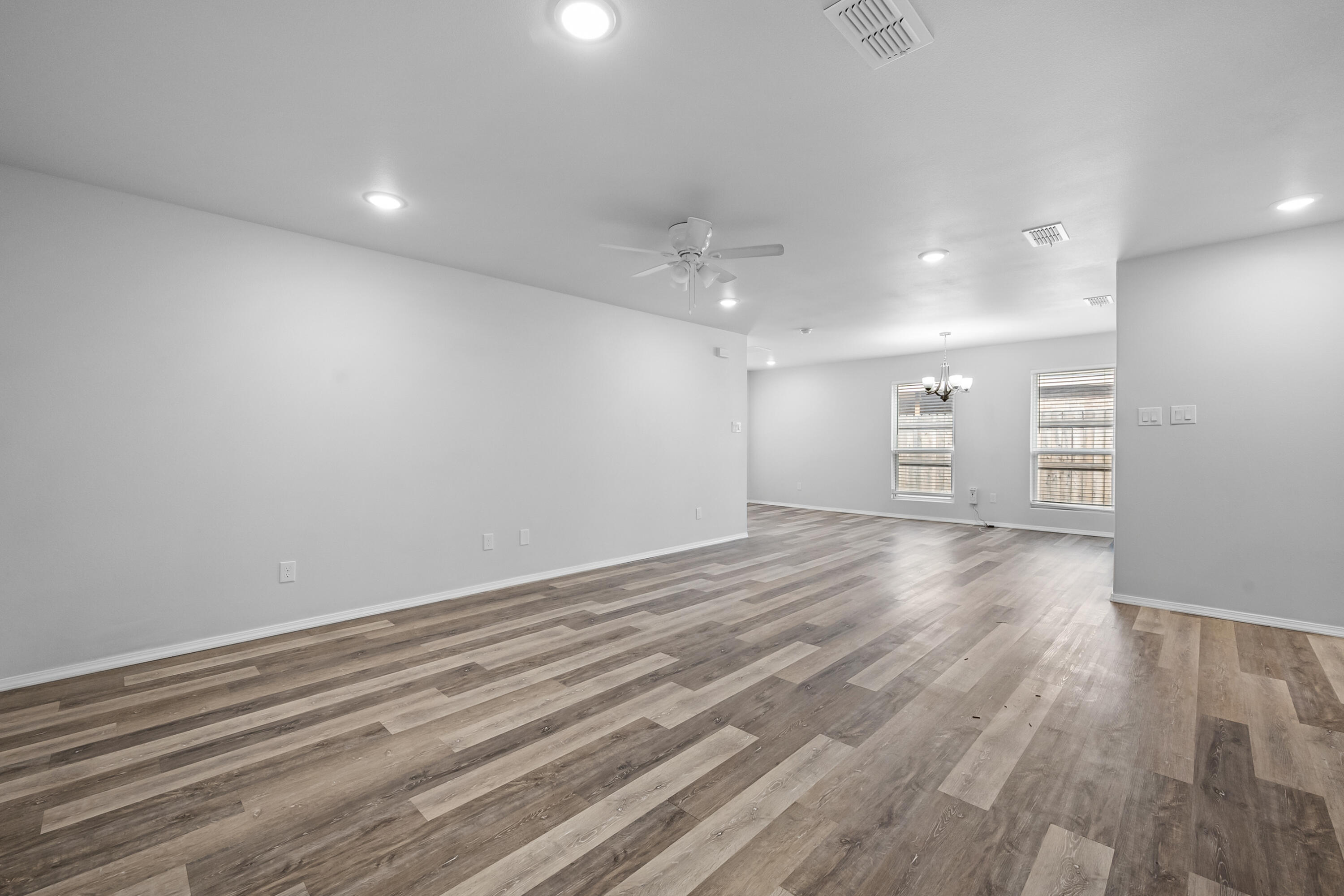5609 Jarvis Street, Unit B Lubbock, TX 79416 - Photo 9 of 24 wooden floor in an empty room with a window