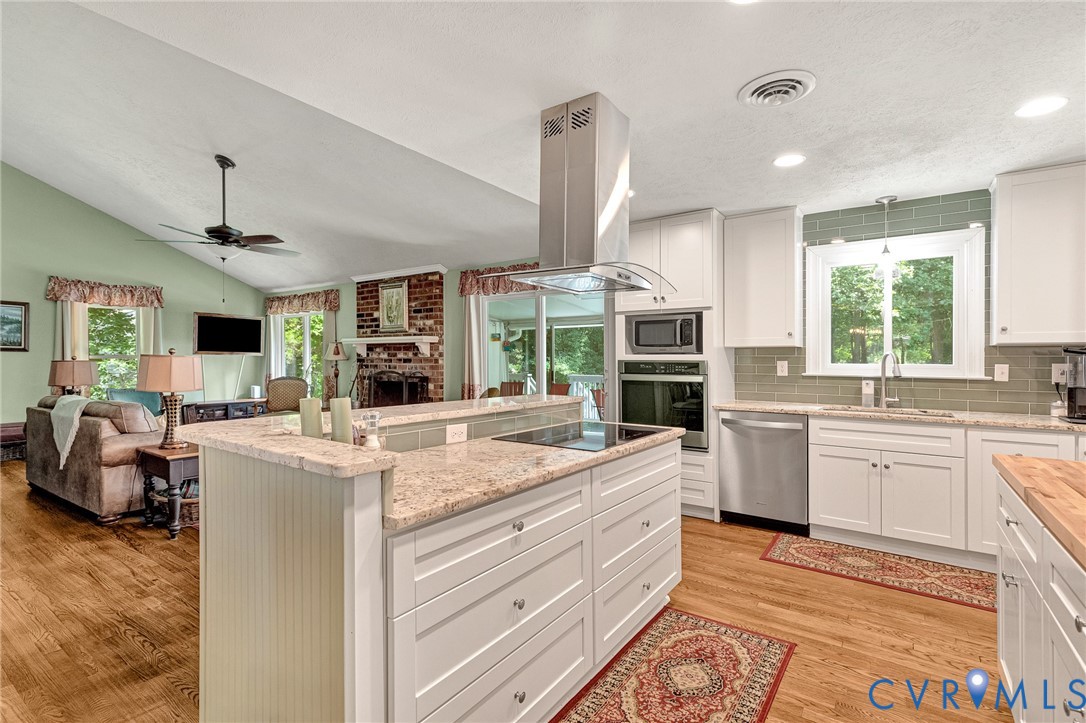3841 Strawhill Road Richmond, VA 23231 - Photo 5 of 56 Kitchen featuring white cabinetry, light-colored c